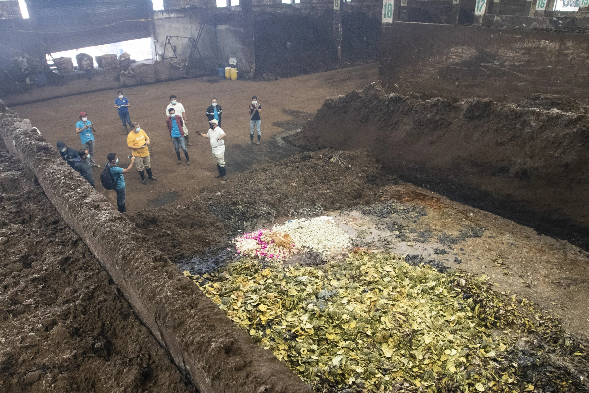 Dr. Bo showing the guests a compartment filled with fruit peelings and egg shells
