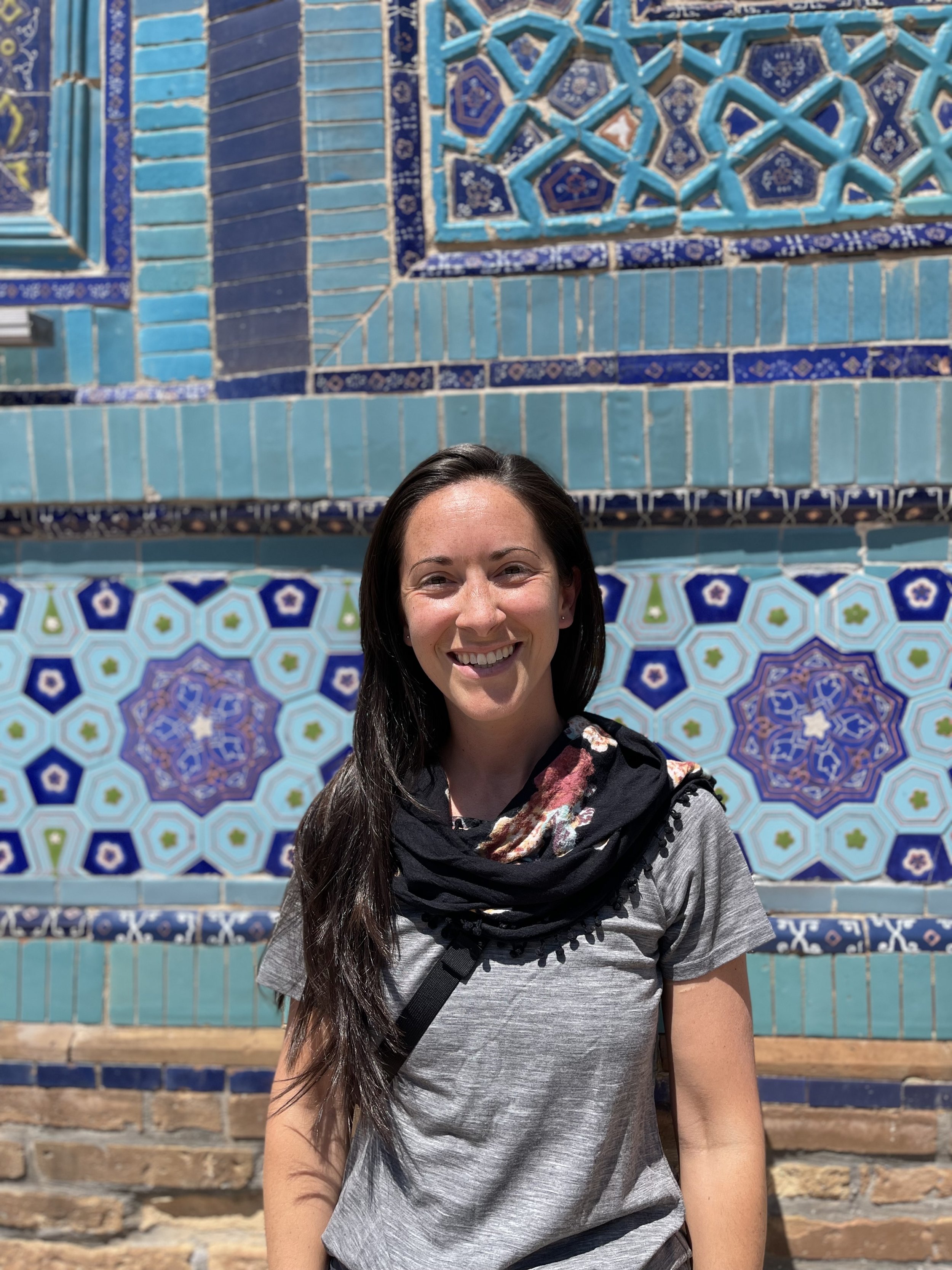 Dark haired girl, smiling, backpacking Central Asia, Samarkand, Uzbekistan.