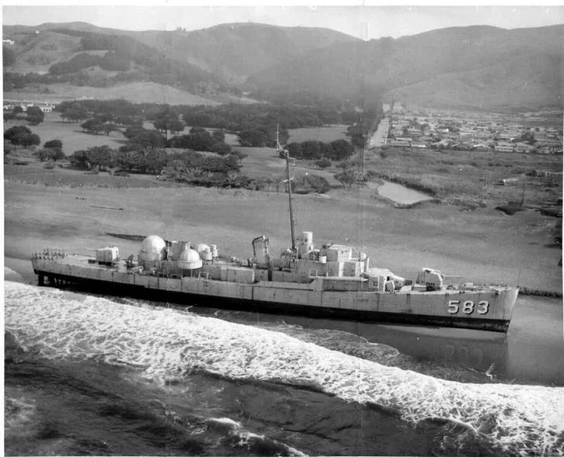 GEORGE A. JOHNSON breaks free of her tow line and washes ashore. 