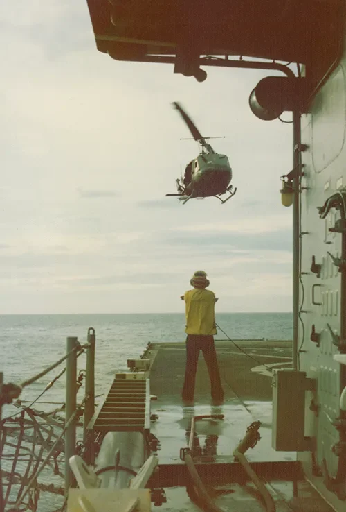 KIRK airman stand by as a UH-1 Huey lands on their small flight deck during the evacuation, April 1975.  