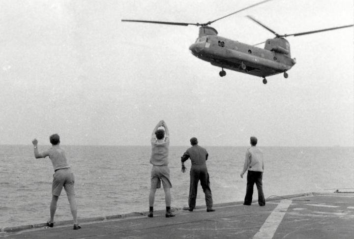KIRK crewman directing a Chinook onto the small flight deck, April 1975. 