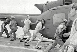 KIRK crew disposing of a helicopter after rescuing its survivors, April 1975. 