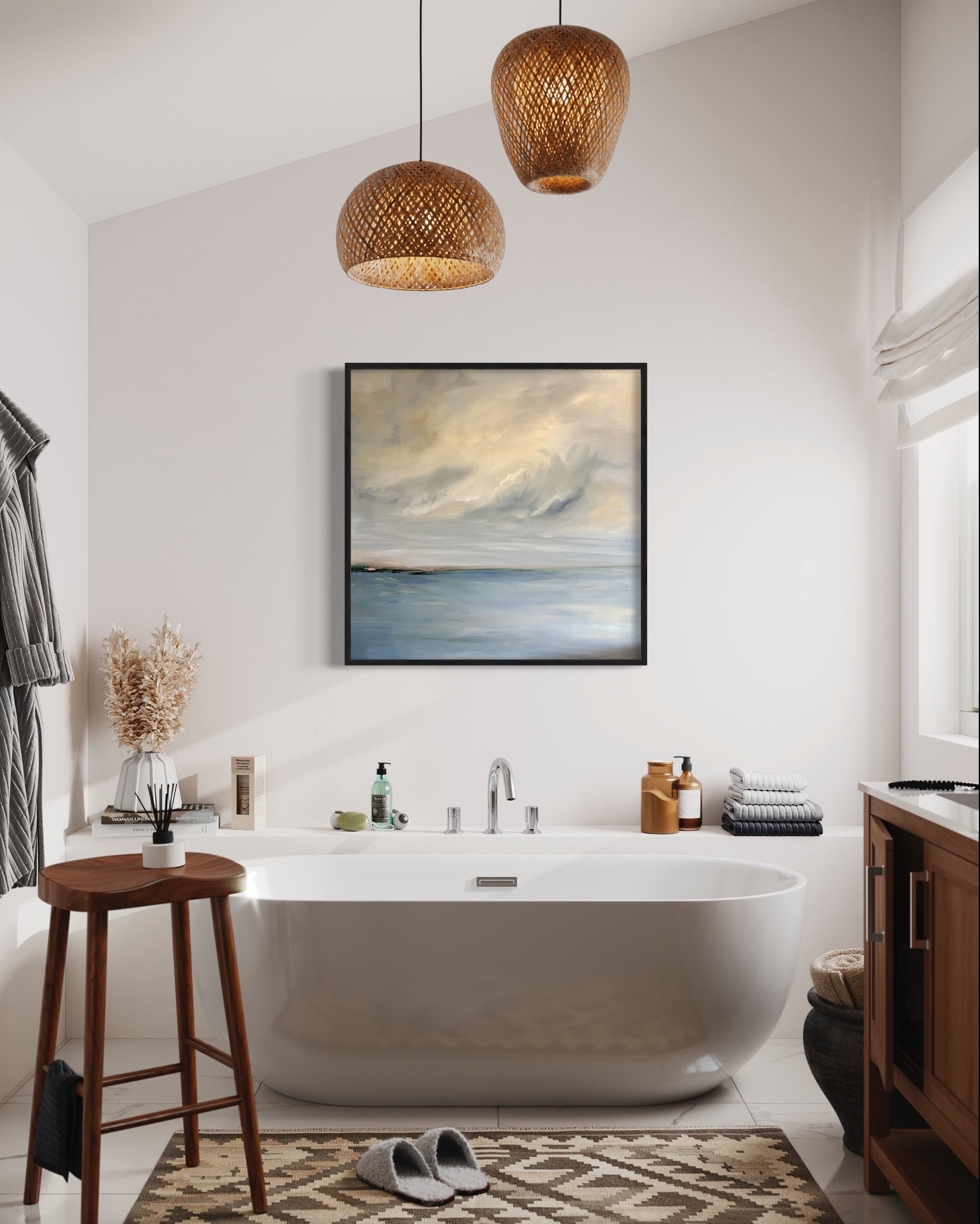 A bathroom with a white bathtub under a window, a wooden stool, a woven basket, a floor mat, and a framed painting of a seascape. Two hanging woven pendant lights are above.