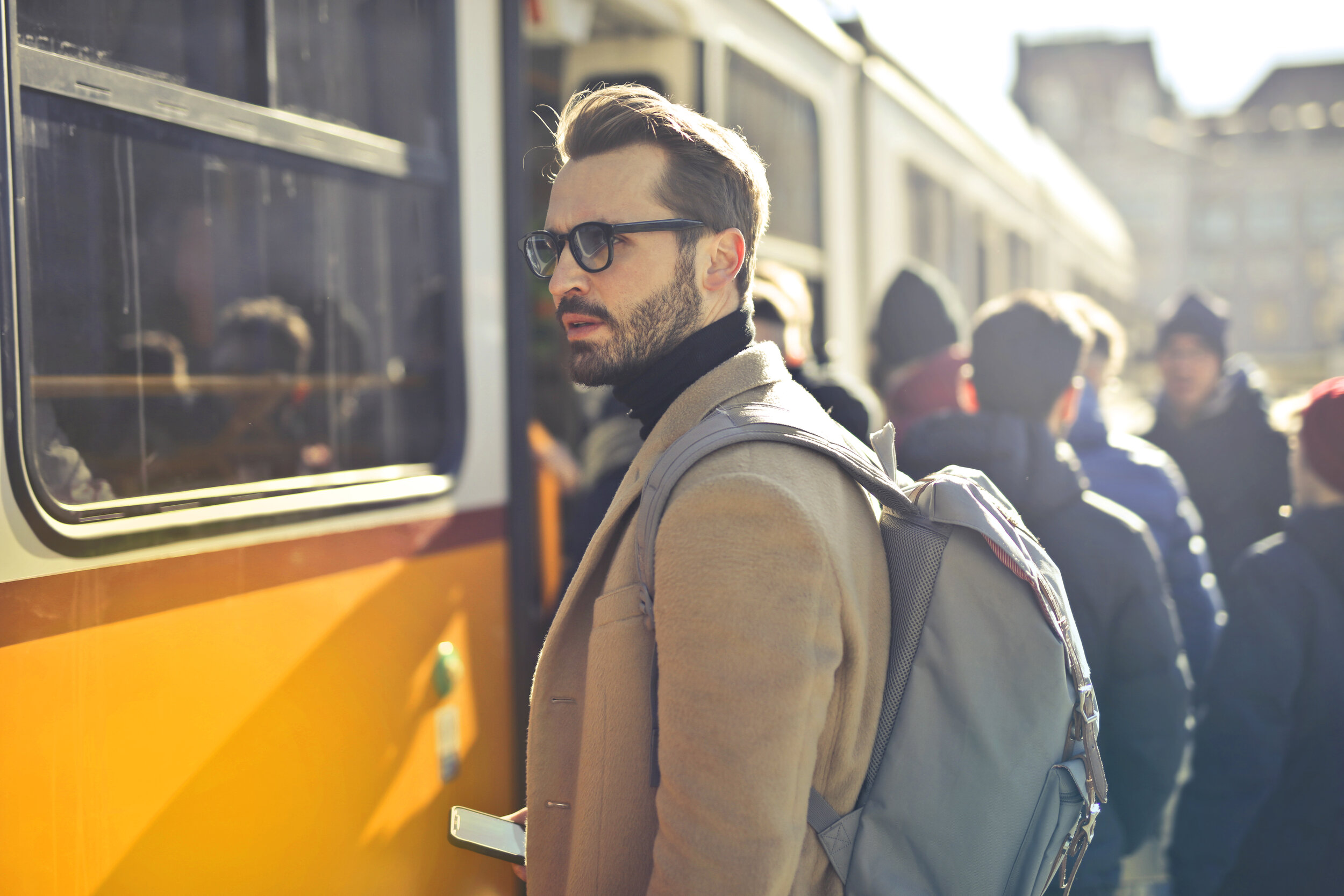 man-in-brown-coat-and-gray-backpack-posing-for-a-photo-837358.jpg