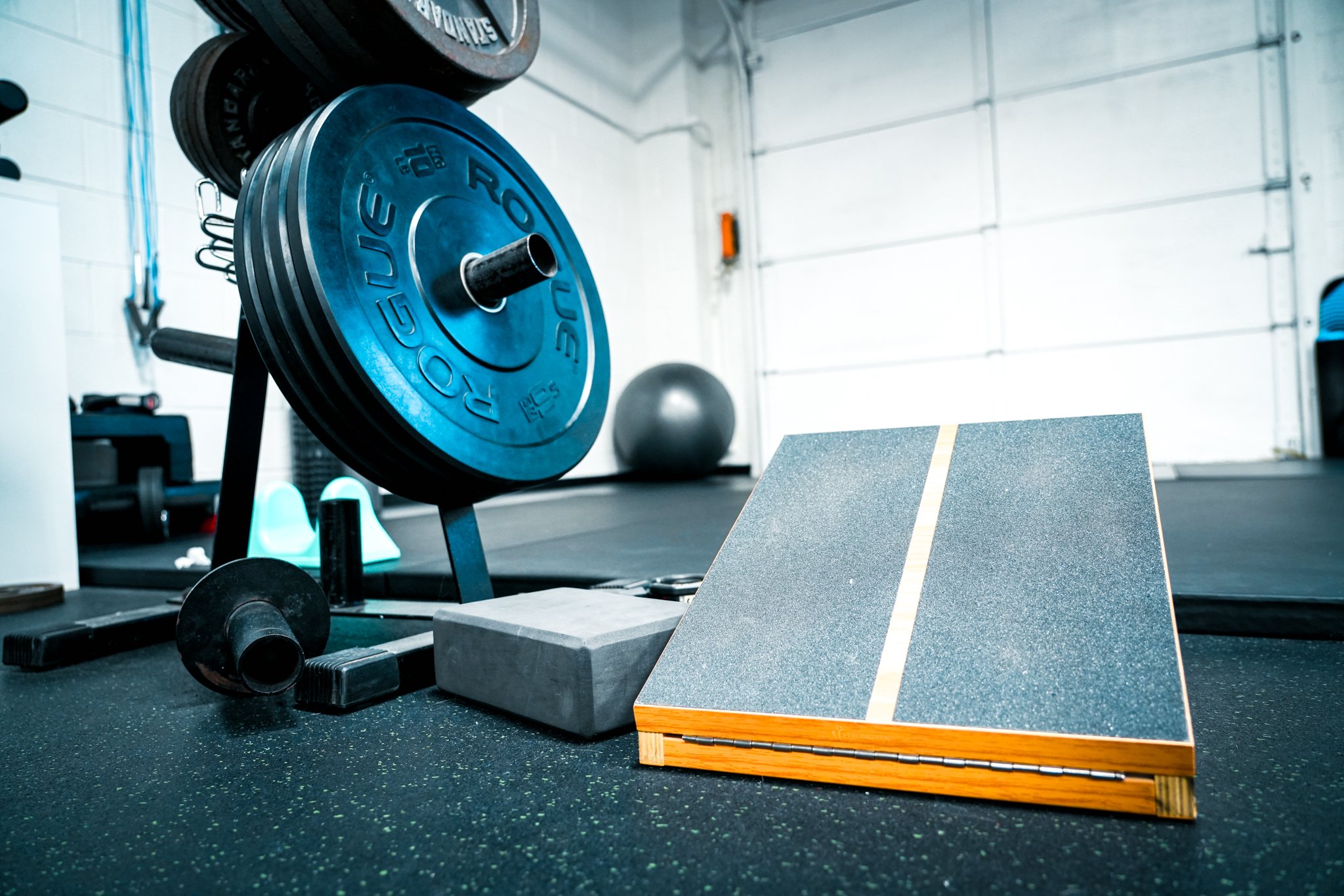 Strength and Conditioning at Movement Art Jit-Jitsu. Slant board and Rogue weight plates.