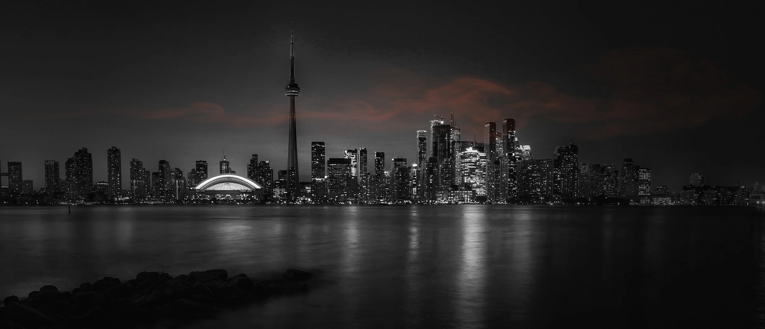 skyline of Toronto, black and white with orange clouds