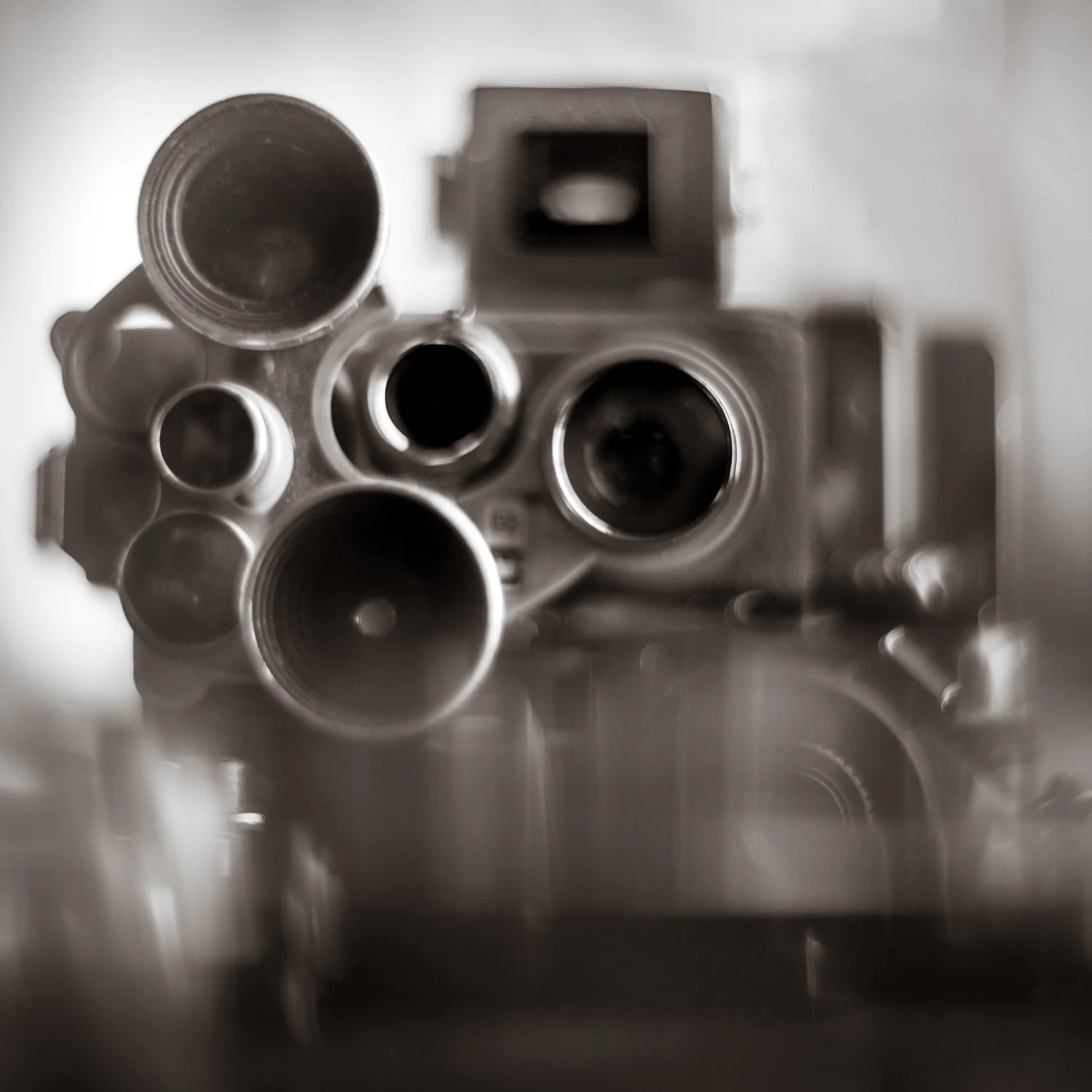 A camera with multiple lenses photographed by Mark Robert Halper in black and white.