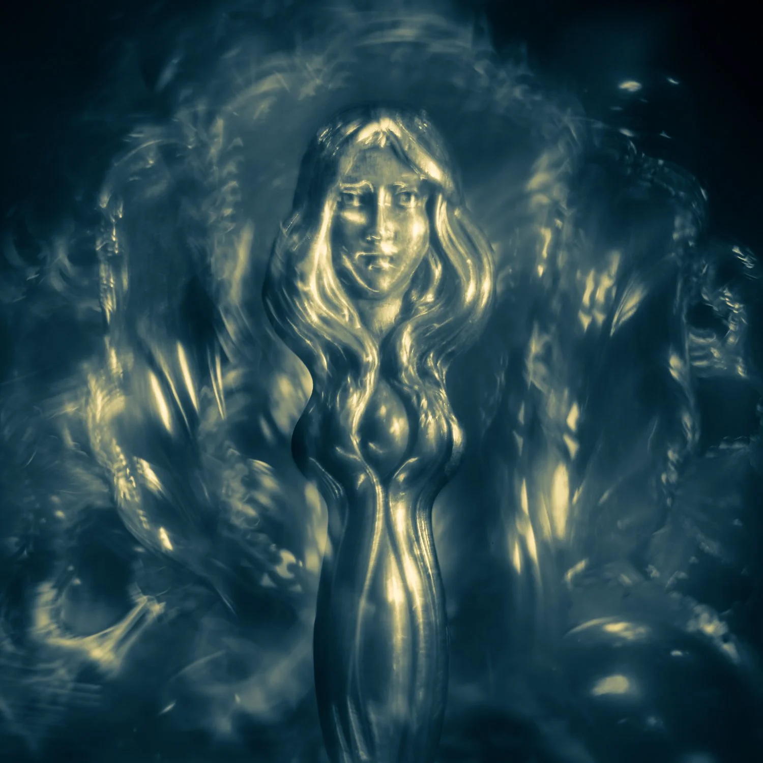 A figurine photographed by Mark Robert Halper in blue and golden light.