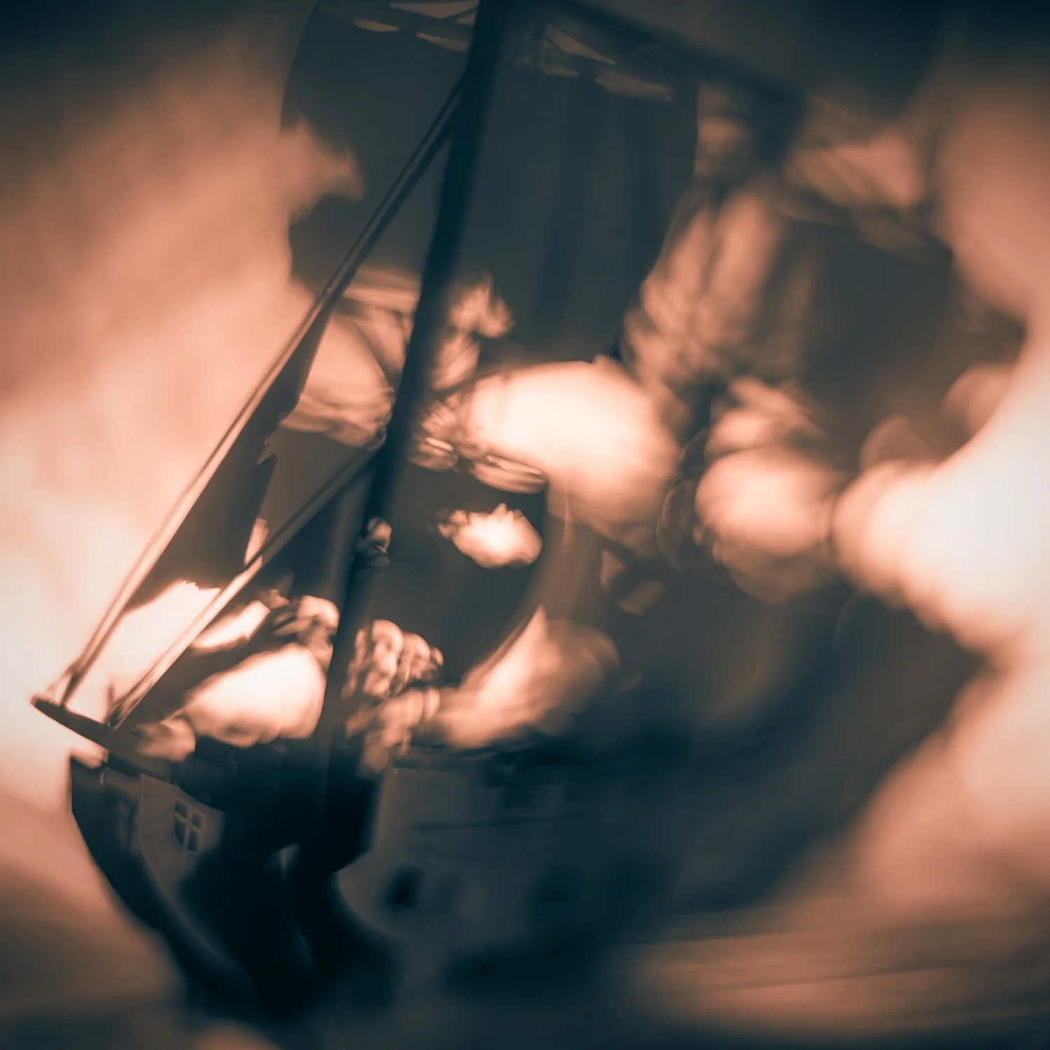 A sailing ship transformed by copper light, photographed by Mark Robert Halper.