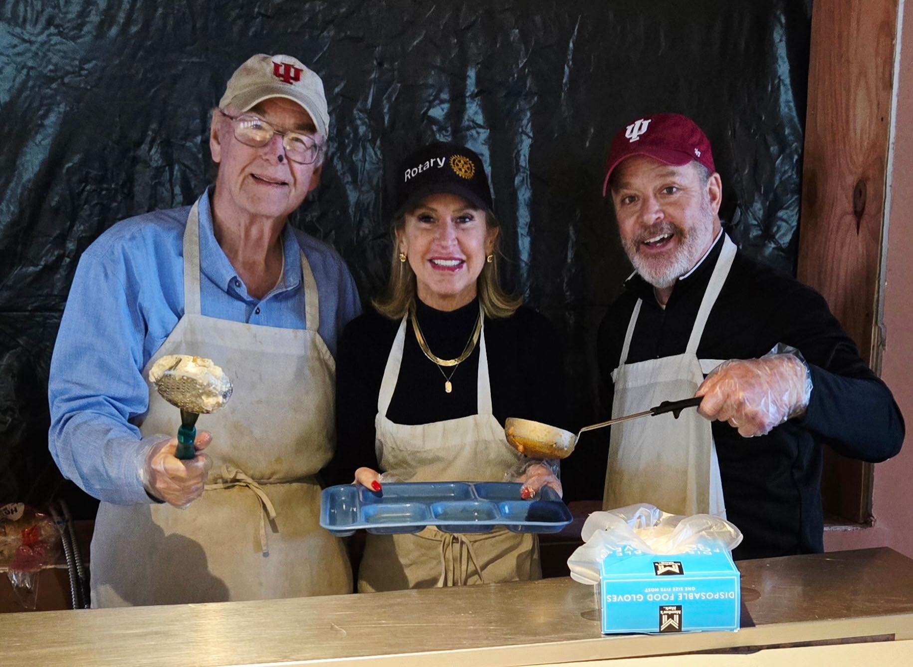 Rotarians in service!
Rotarians Phil , Joni and Tyler serve up a hot meal.