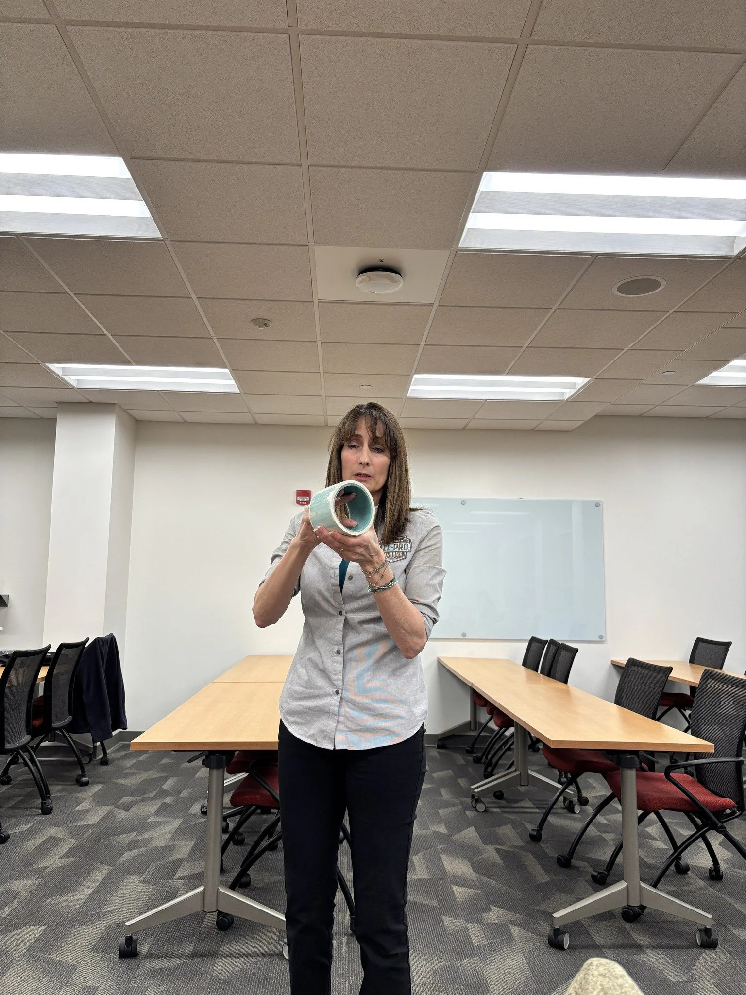 All-Pro Plumbing co-owner Kim Tracy illustrates how new technology allows plumbers to treat and seal pipe interior, reducing leaks and strengthening older pipe systems.