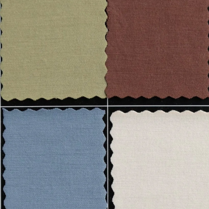 Swatches of fabric in white, burgundy, beige, and purple.