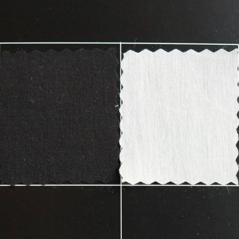 Four fabric swatches arranged in a grid, from top left to bottom right: navy blue, white, brown, black.