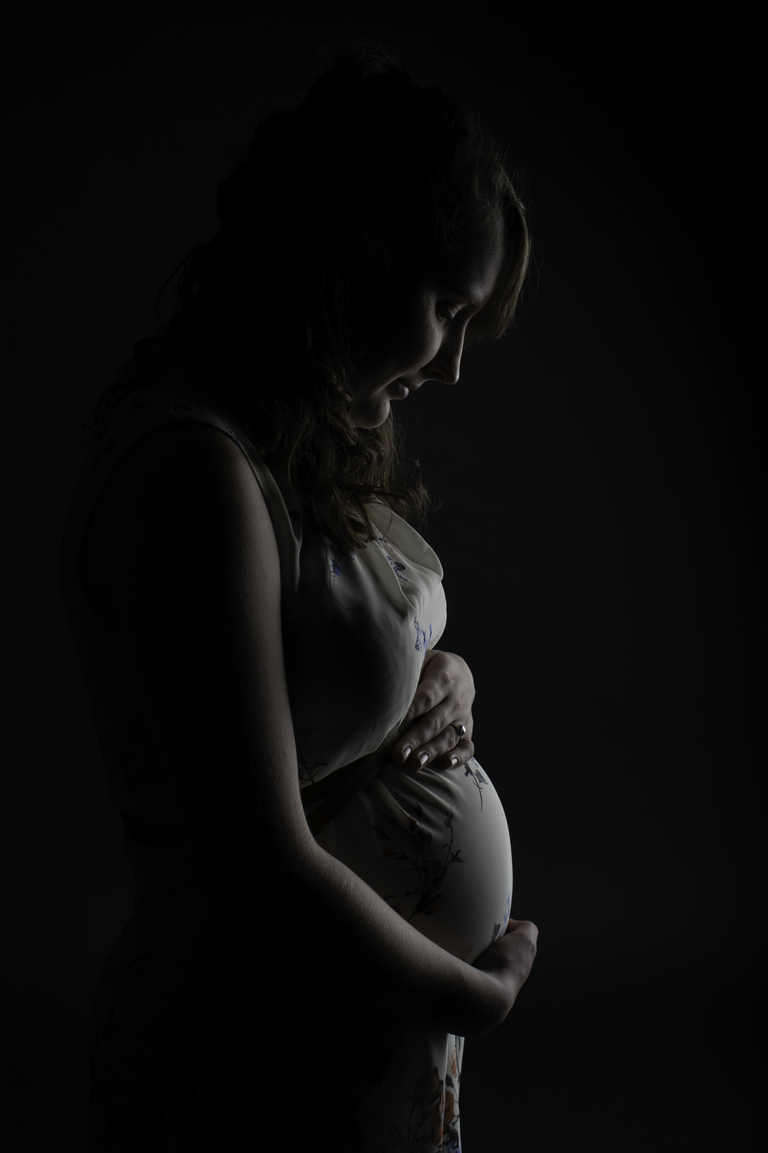A maternity portrait in a studio setting