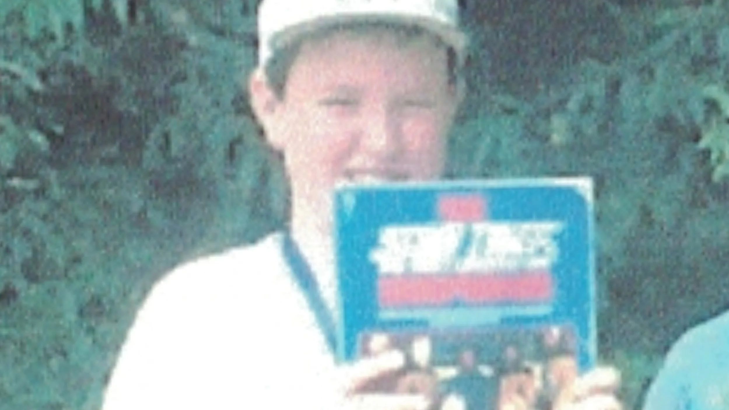 Young Shamus holds up a Star Trek: The Next Generation book in a camp group photo.