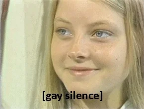 A gif of a young Jodie Foster looking at an interviewer with a shit eating grin on her face. The caption reads "[gay silence]"