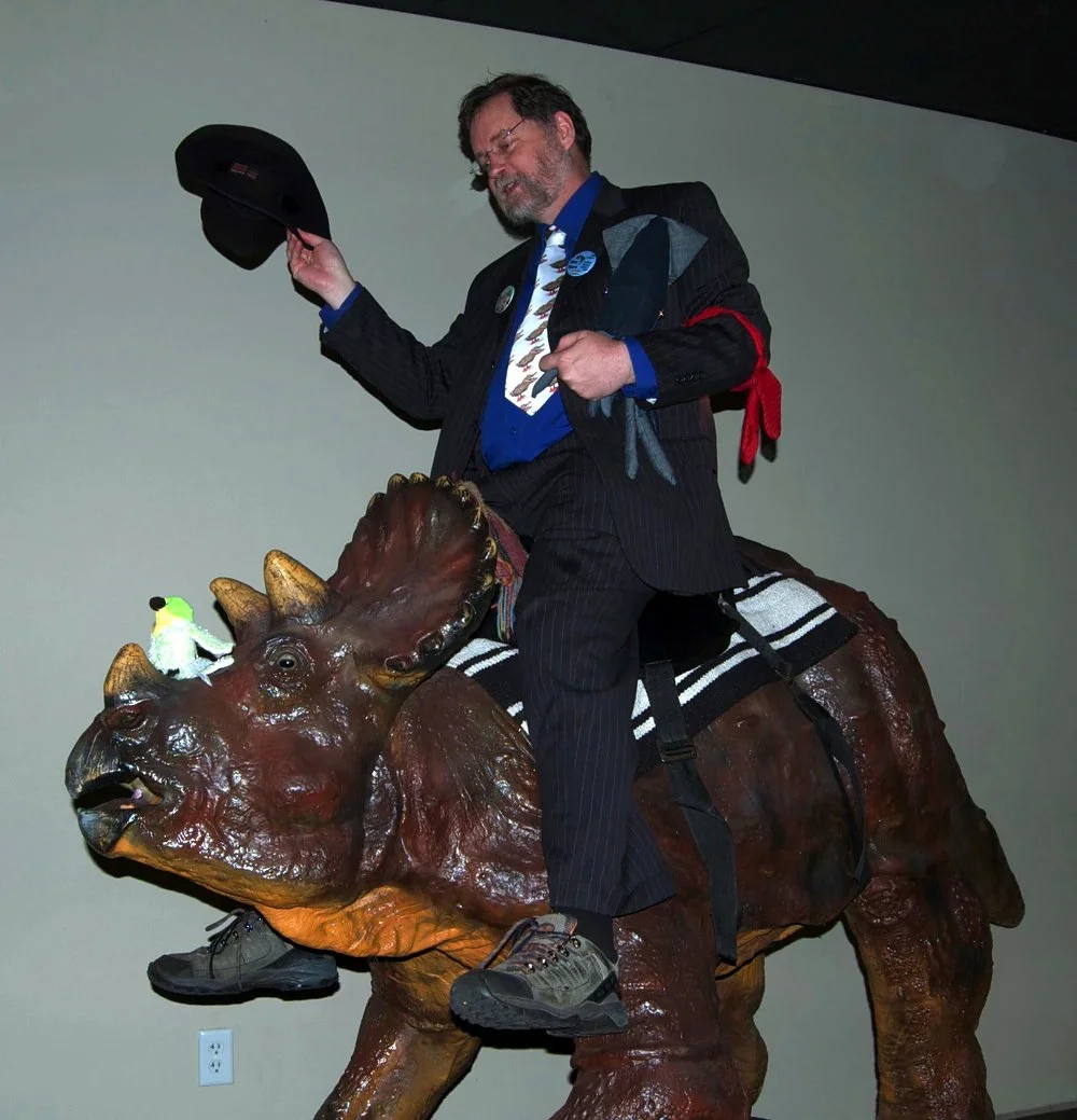 iology professor and avid critic of young earth creationism PZ Myers riding a dinosaur sculpture at the Answers in Genesis Creation Museum.