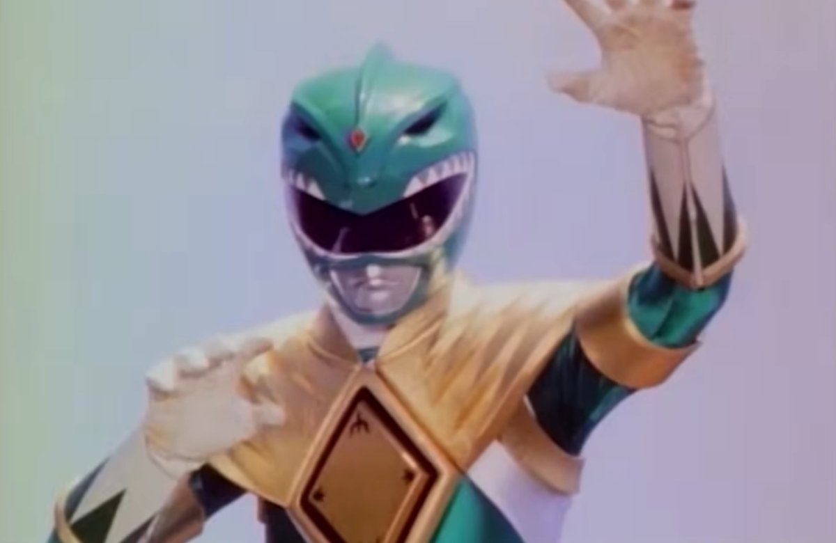 The Green Ranger stands triumphant over the other Power Rangers.