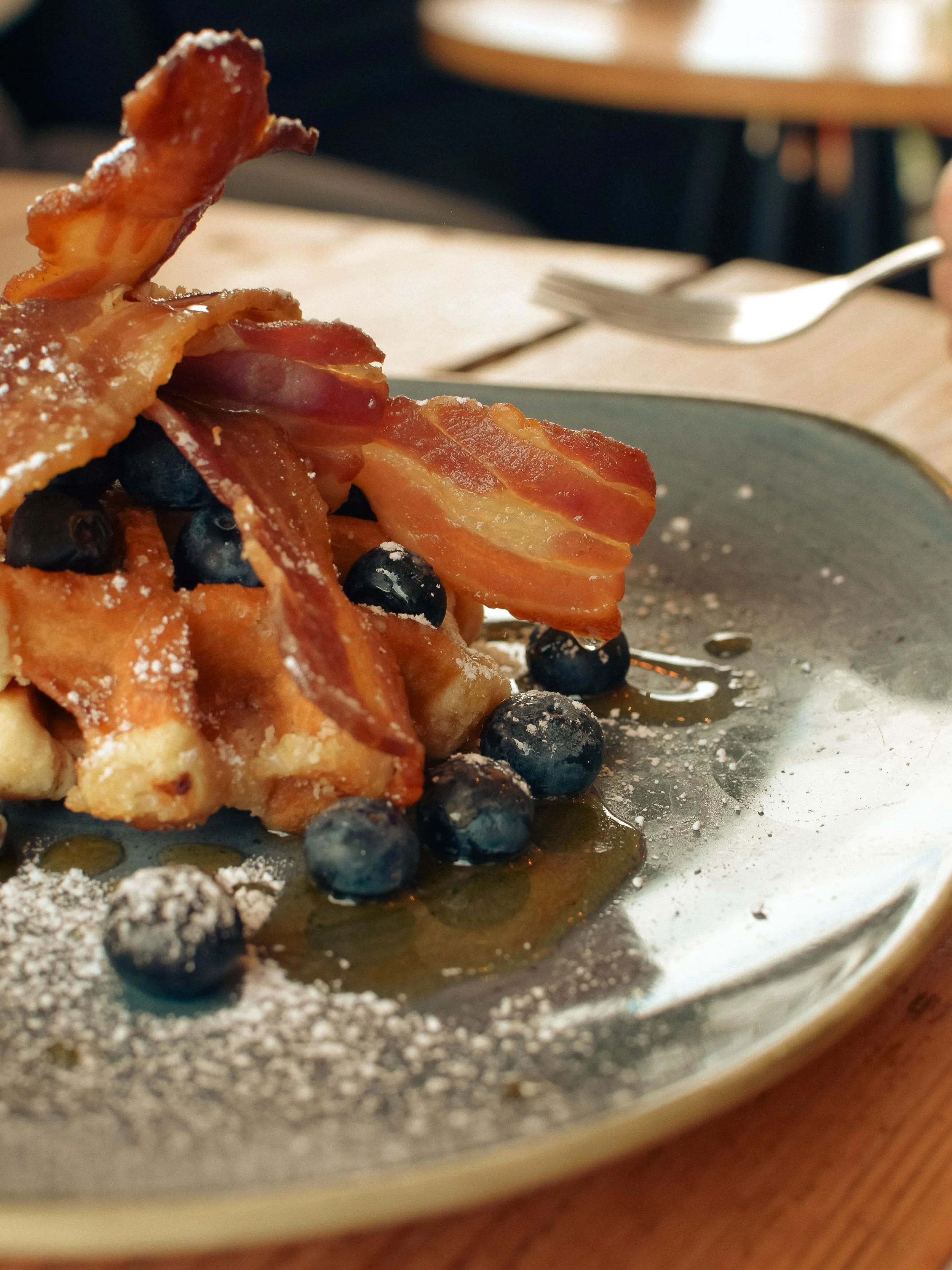 Life  just got sweeter..

Our new Belgian Waffles are here &mdash; toasted to perfection, topped with fresh blueberries, crispy smoked streaky bacon, a drizzle of rich maple syrup, and a light dusting of icing sugar.

Sweet, savoury, and seriously ir