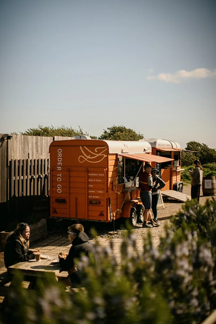 three people ordering and collecting food from Drift Eatery cafe trailer in east lothian