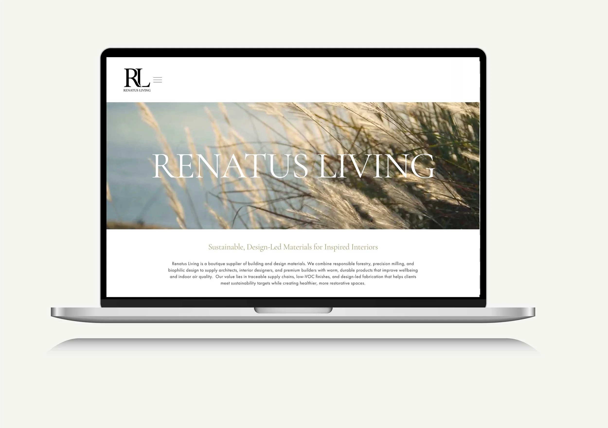 Laptop displaying the homepage of Renatus Living, a company specializing in sustainable, design-led building materials, with a nature-inspired background image