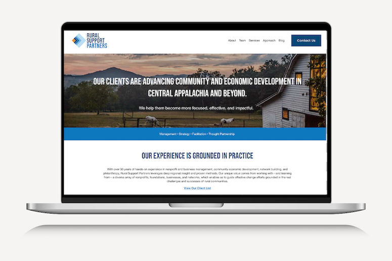 Screenshot of a website homepage for Rural Support Partners, featuring an outdoor rural scene with mountains, trees, a barn, and sheep, emphasizing community and economic development support.