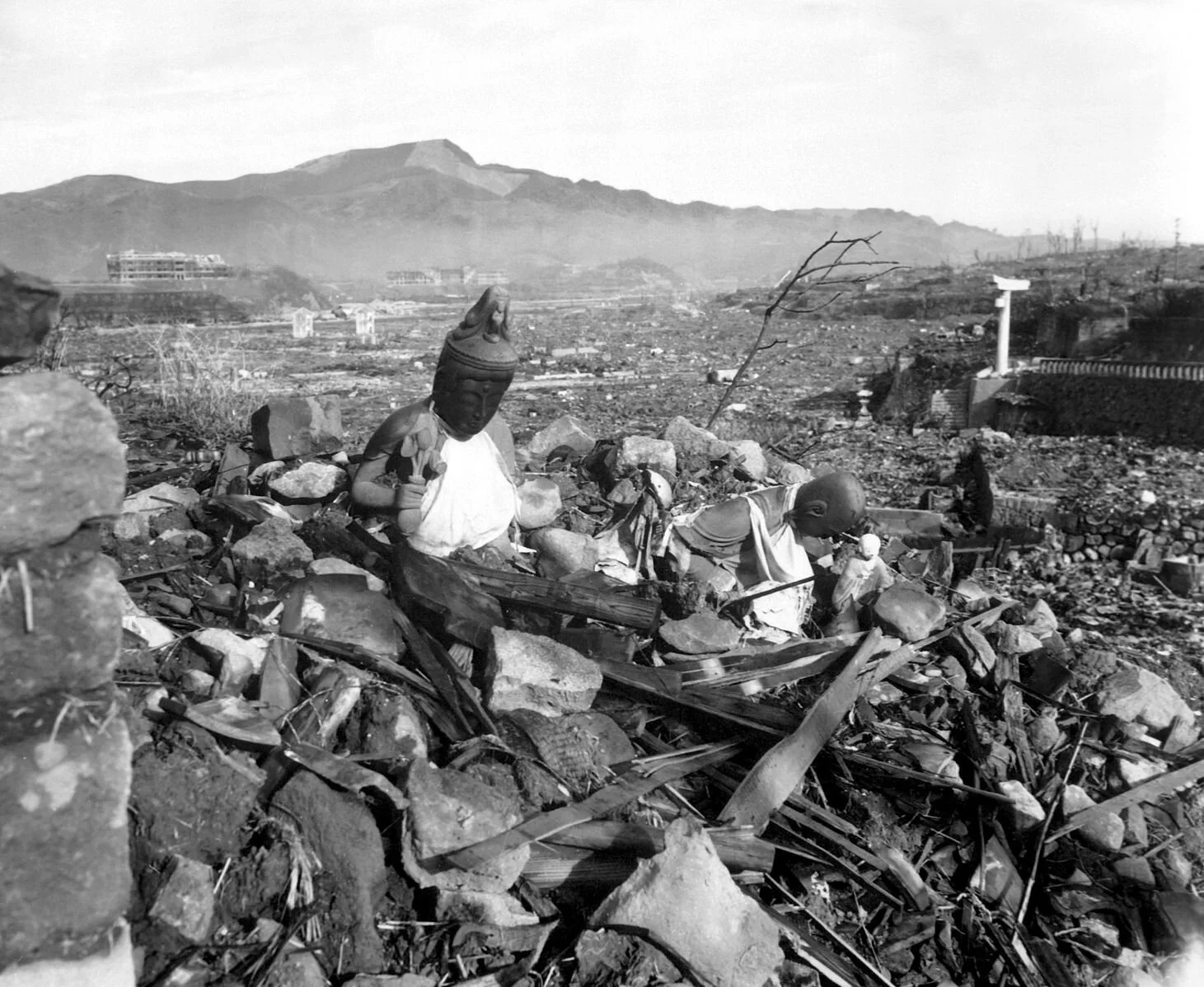 Nagasaki Temple. Battered religious figures stand watch on a hill above a tattered valley. Nagasaki, Japan. September 24, 1945, 6 weeks after the city was destroyed by the world's second atomic bomb attack. Photo by Cpl. Lynn P. Walker, Jr. (Marine Corps).