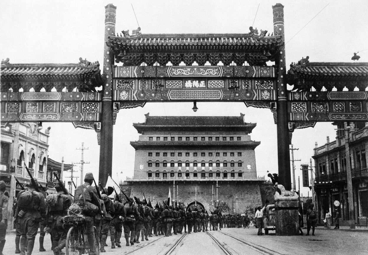 The Japanese occupation of Peiping (Beijing) in China, on August 13, 1937. Japanese troops are shown passing from Peiping into the Tartar City through Zhengyangmen, the main gate leading onward to the palaces in the Forbidden City. Retrieved from Wikipedia Commons.