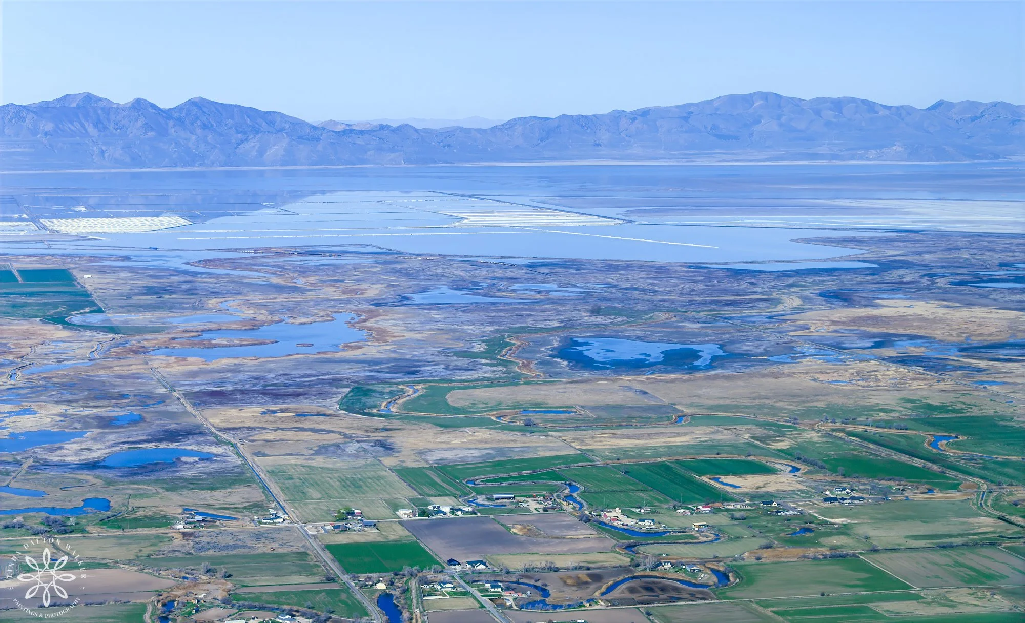 Aerial shot of a valley with great salt lake in distance