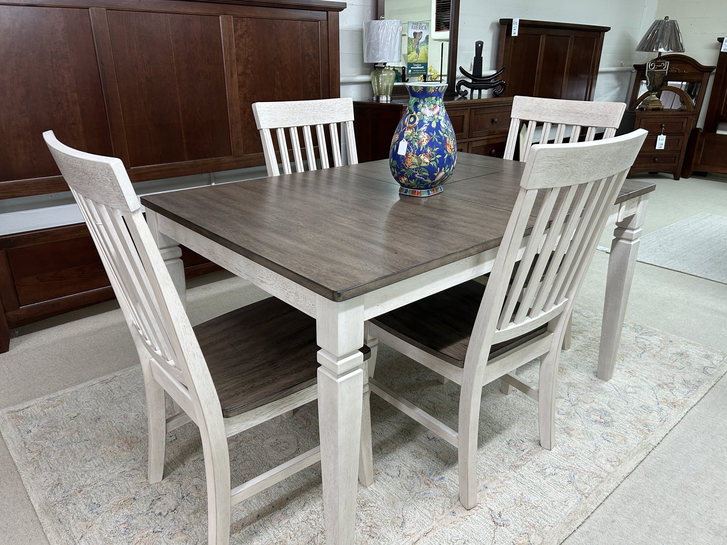 A-America - dinette table with 18” self-storing butterfly leaf and 4 slatback side chairs in smoky white and peppercorn finish. Table measures 36” W x 36” L (expands to 54”) x 30” high