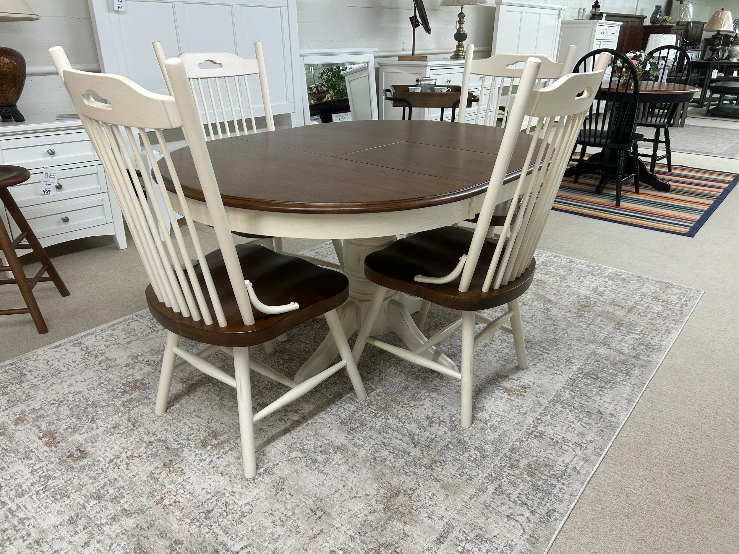 TEI - Windswept Shores 42“ solid hardwood round table with butterfly self-stored leaf (expands to 42“ x 57“).  Comes with four farmhouse side chairs in two-tone finish (buttermilk and cherry)
