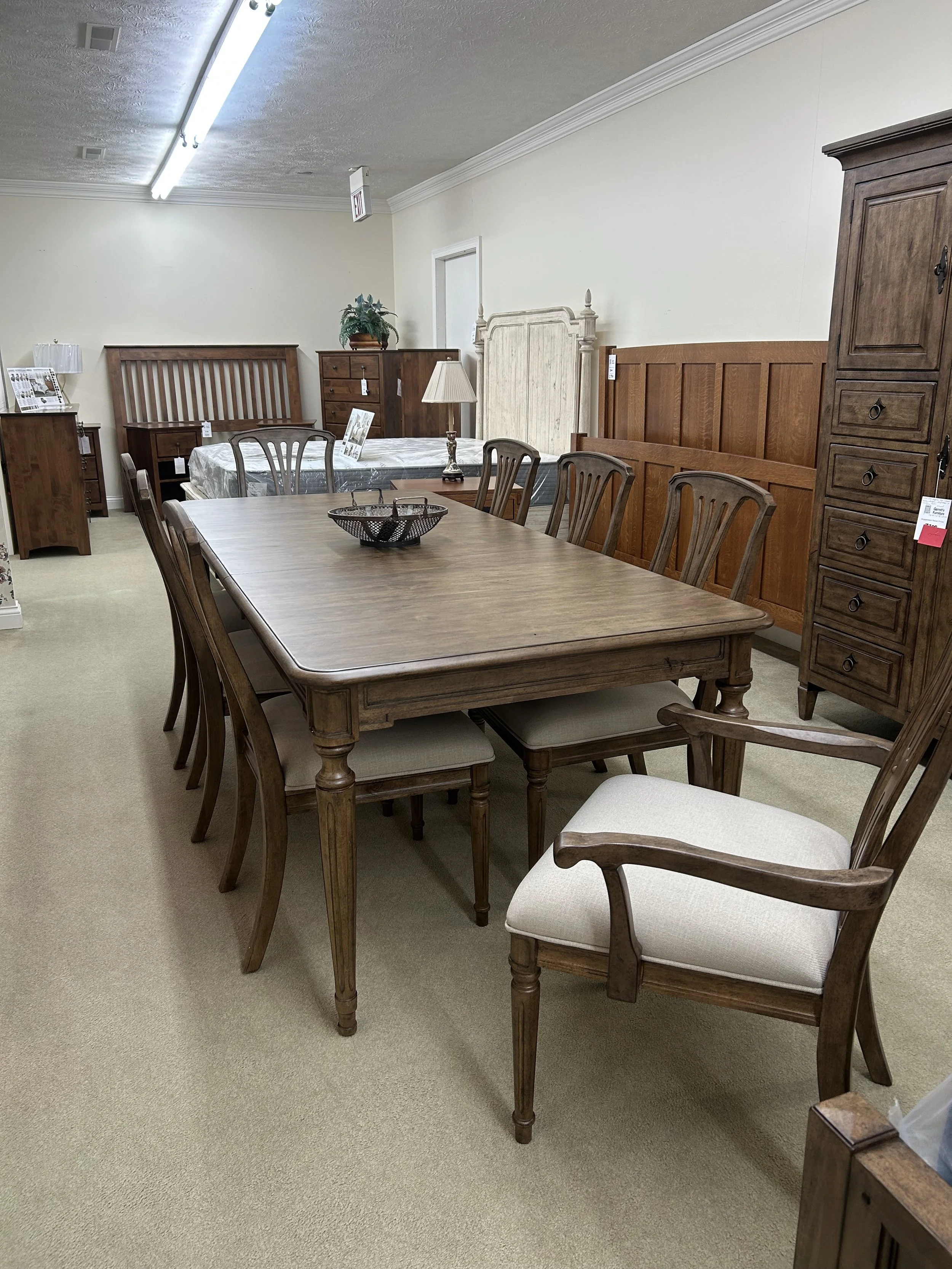 Kincaid solid hardwood 70“ dining table with two 20“ leaves in cinnamon finish on Alder.  Comes with six upholstered side chairs and two upholstered arm chairs (from the Ansley collection).