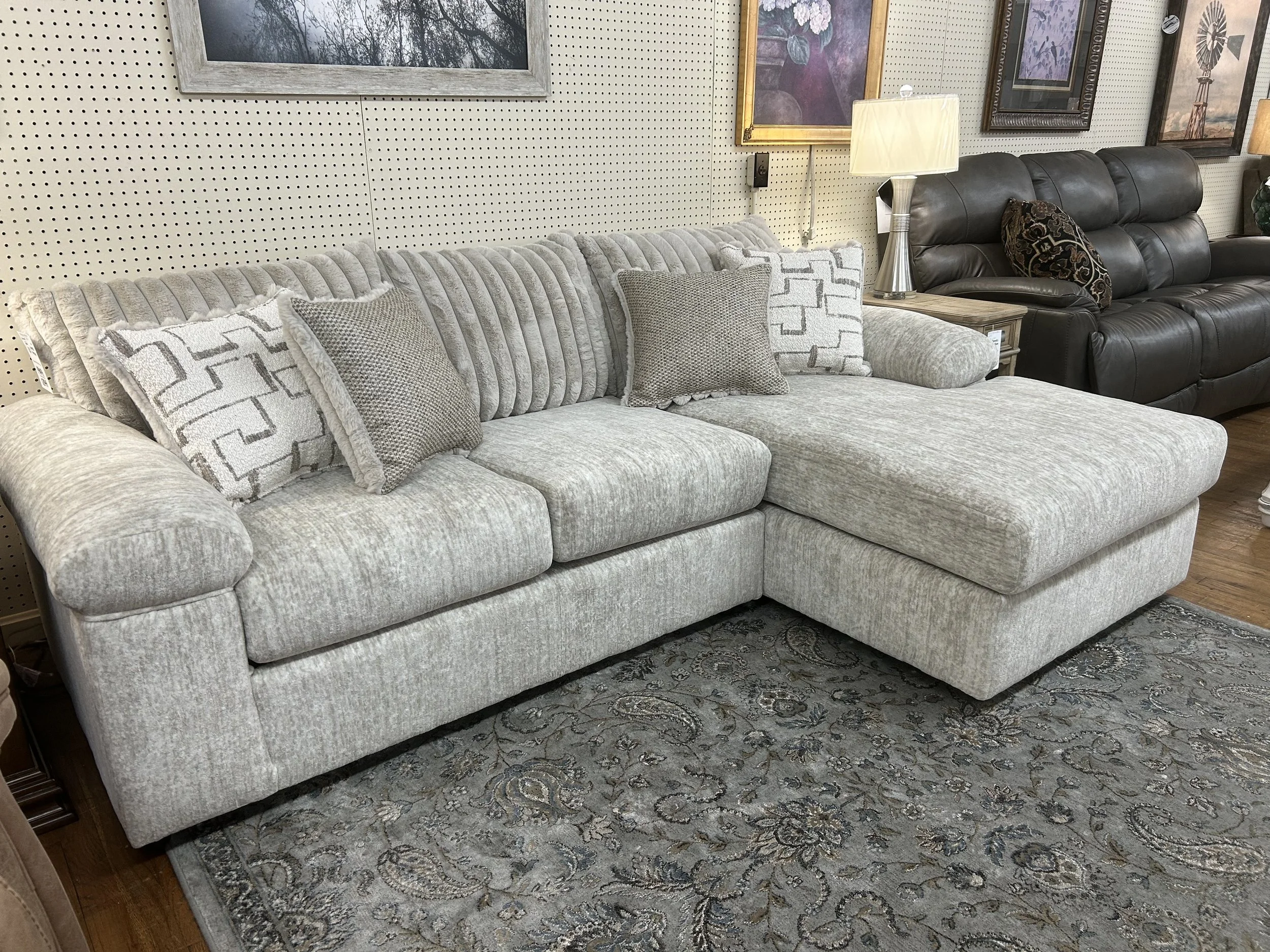 Sofa with one arm chaise in cream fabric made by Hughes Furniture in North Carolina