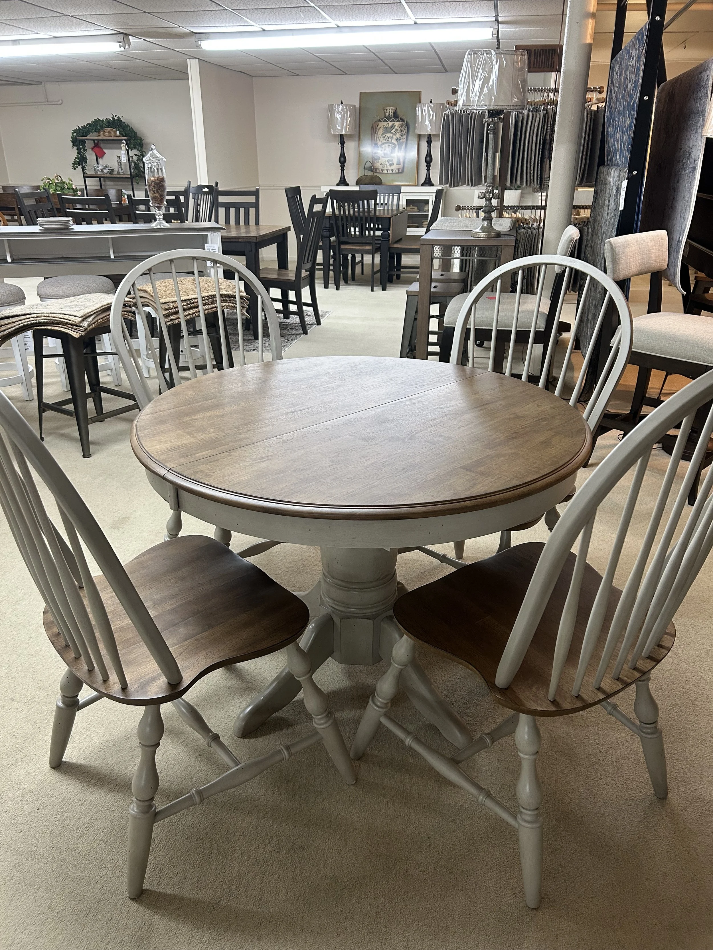 42“ round pedestal dining table with 15“ butterfly self-storing leaf with four side chairs in two-tone grey and oak finish