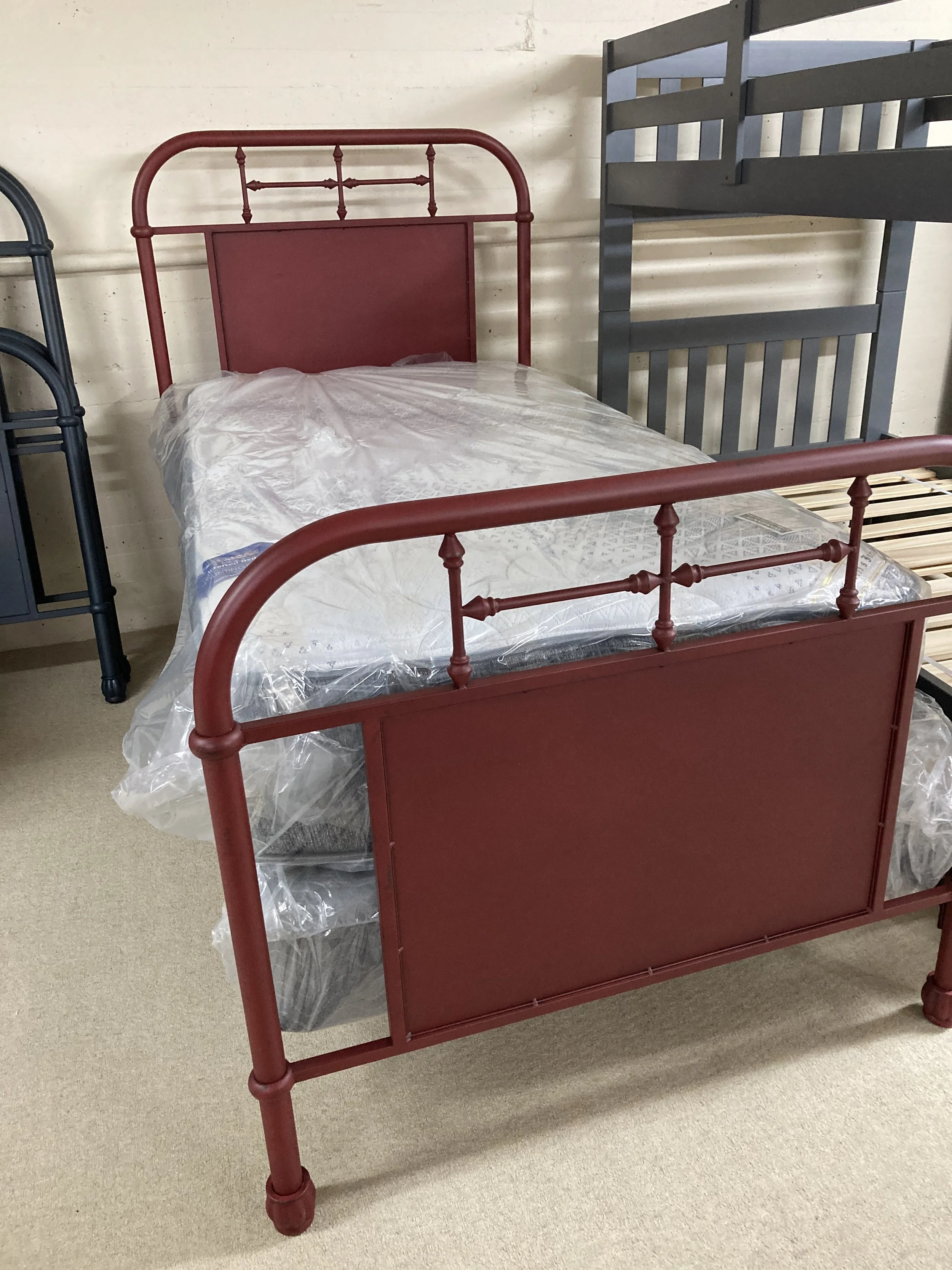 Metal twin bed in rustic red