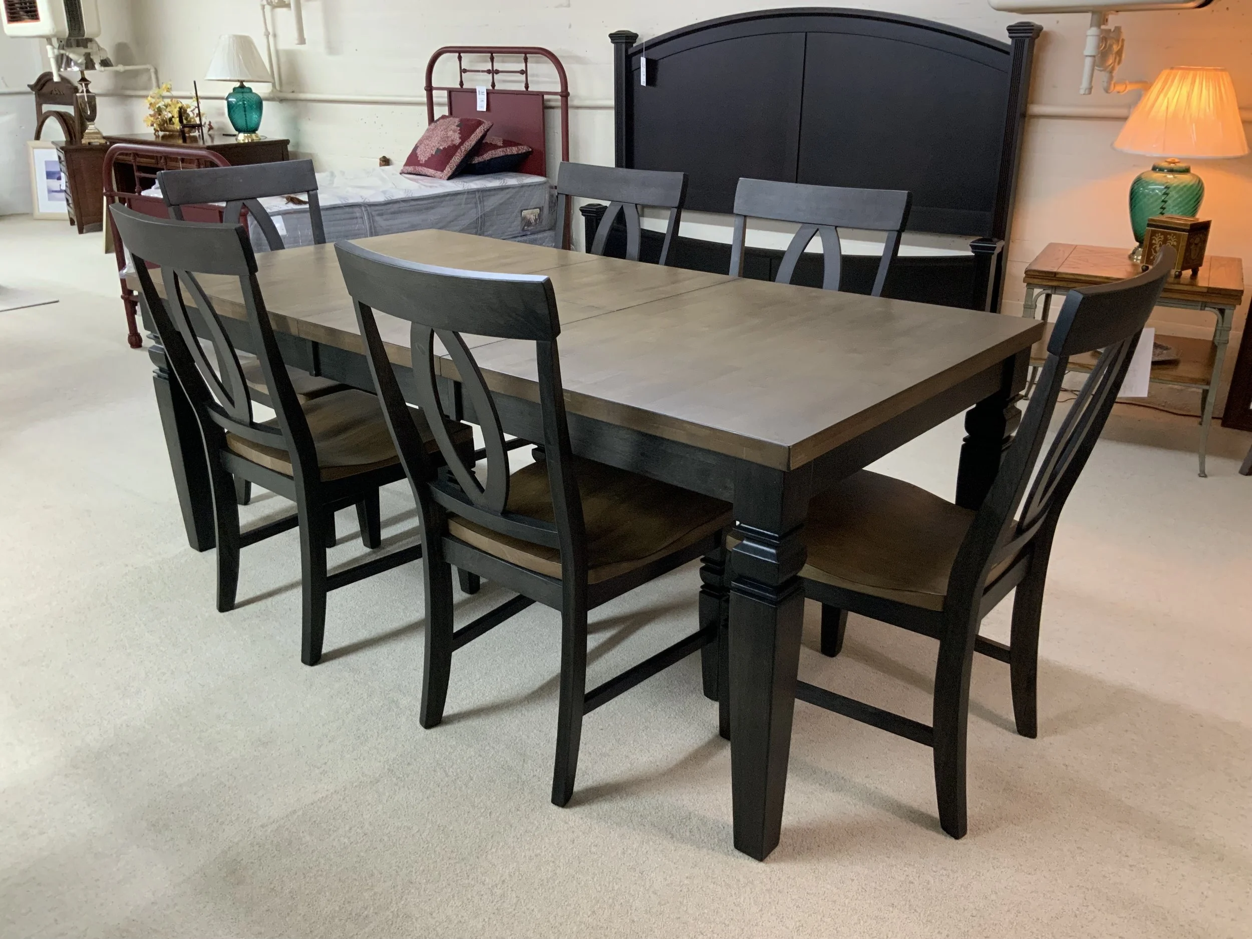 40” x 60” dining table with one 18” butterfly self-storing leaf in charcoal & toffee finish.  Comes with six side chairs by TEI