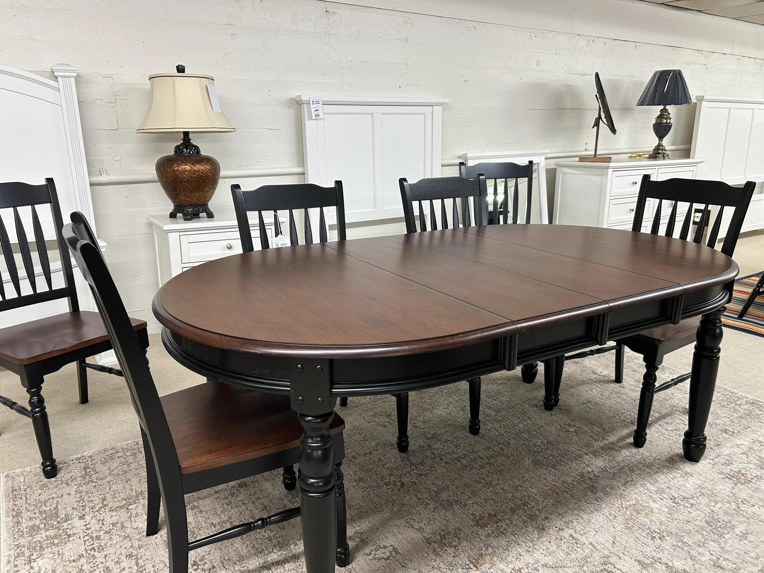 A-America - British Isles oval leg table with 6 slat-back side chairs in oak and black finish on solid hardwood. W: 42” x L: 52” (expands to 76”) x H: 29.75”