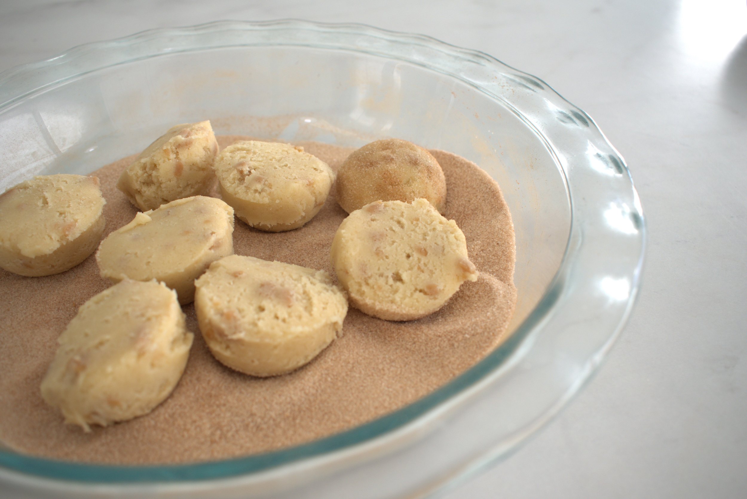 toffee snickerdoodle cookie dough balls in cinnamon sugar.jpg