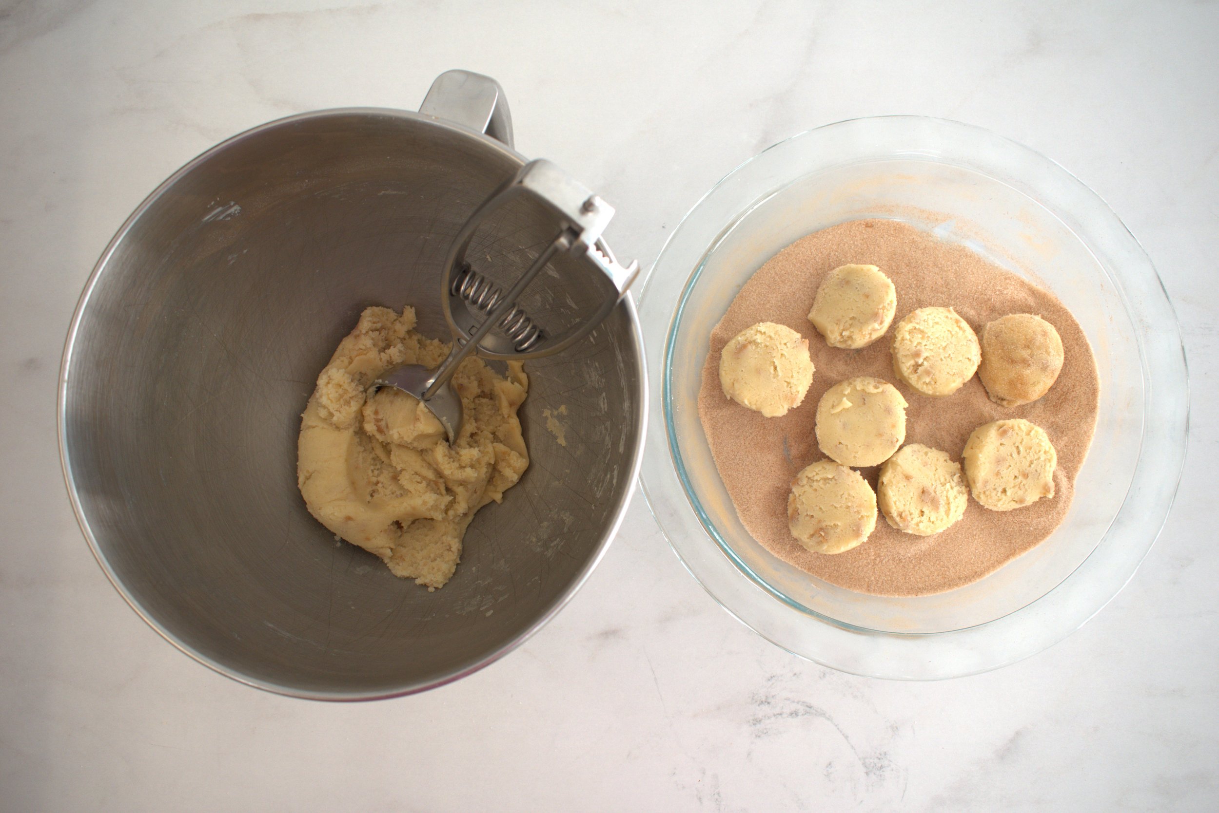 scooping toffee snickerdoodle cookies into cinnamon sugar.jpg