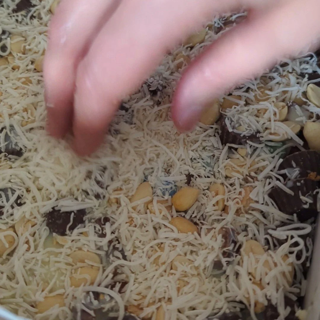 adding coconut to magic bars.jpg