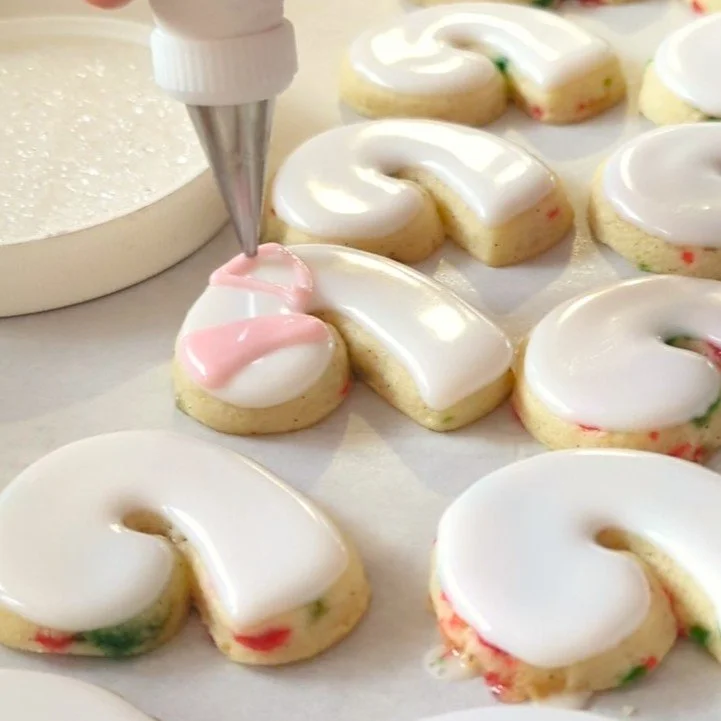 piping stripes on candy cane cookies.jpg
