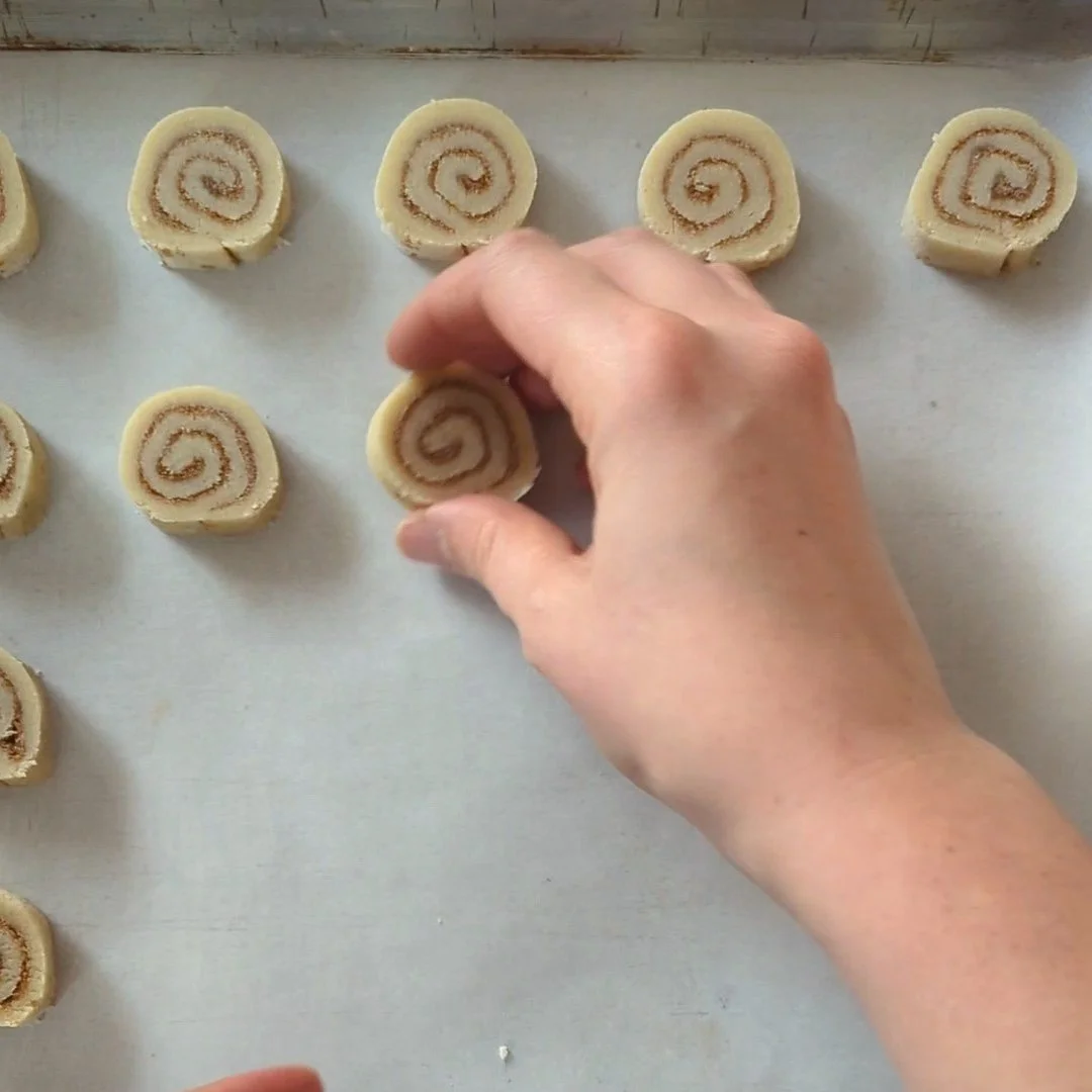 placing cinnamon swirl cookies on tray.jpg