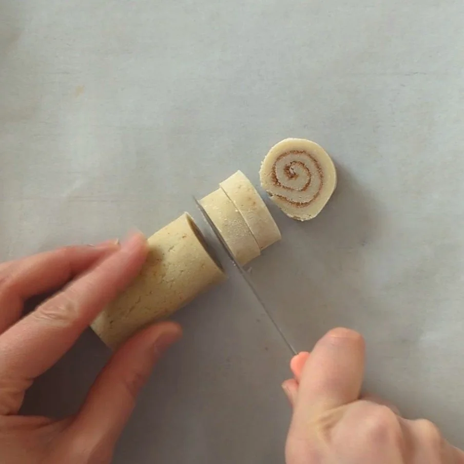 slicing cinnamon swirl cookies.jpg