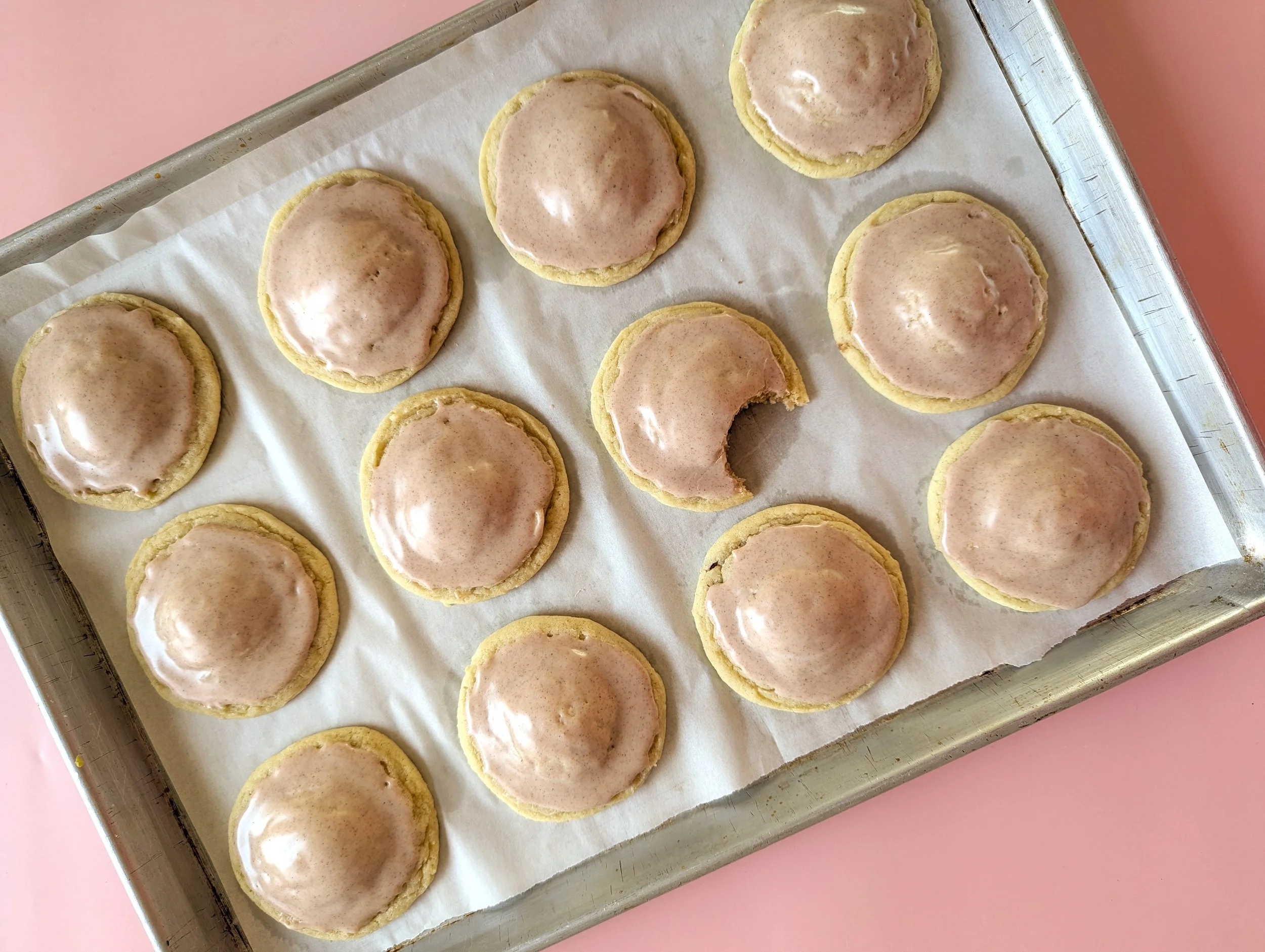brown sugar pop tart cookies on a baking tray sitting on a light pink background
