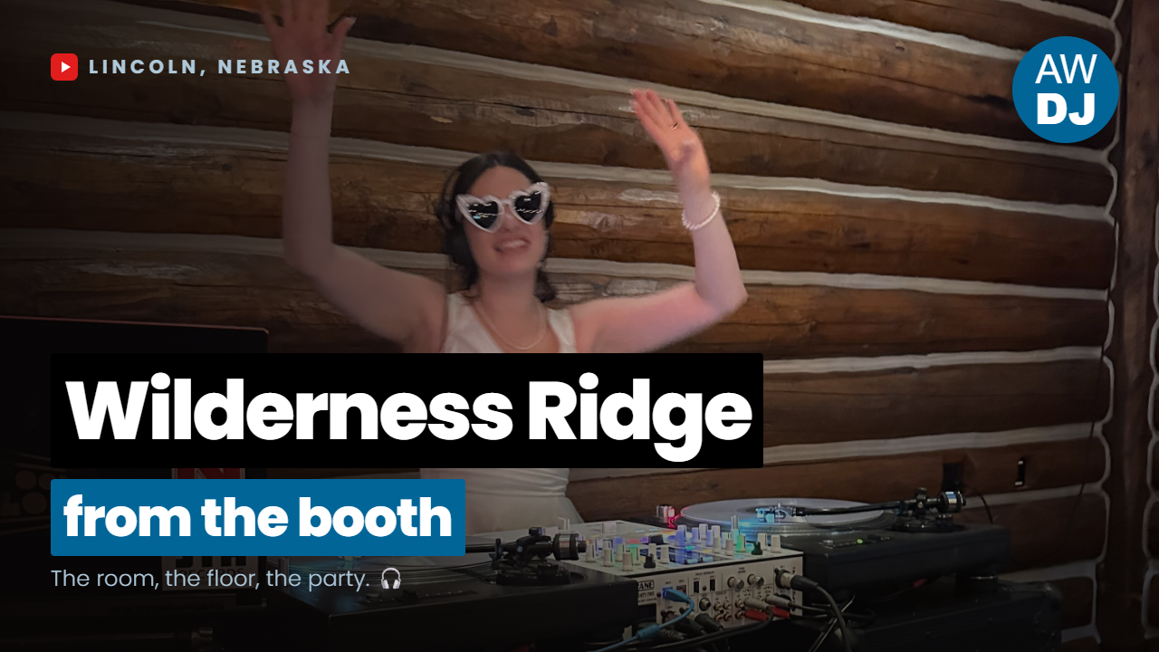 Bride behind DJ Fly Cuts' DJ booth at a Wilderness Ridge wedding in Lincoln, Nebraska