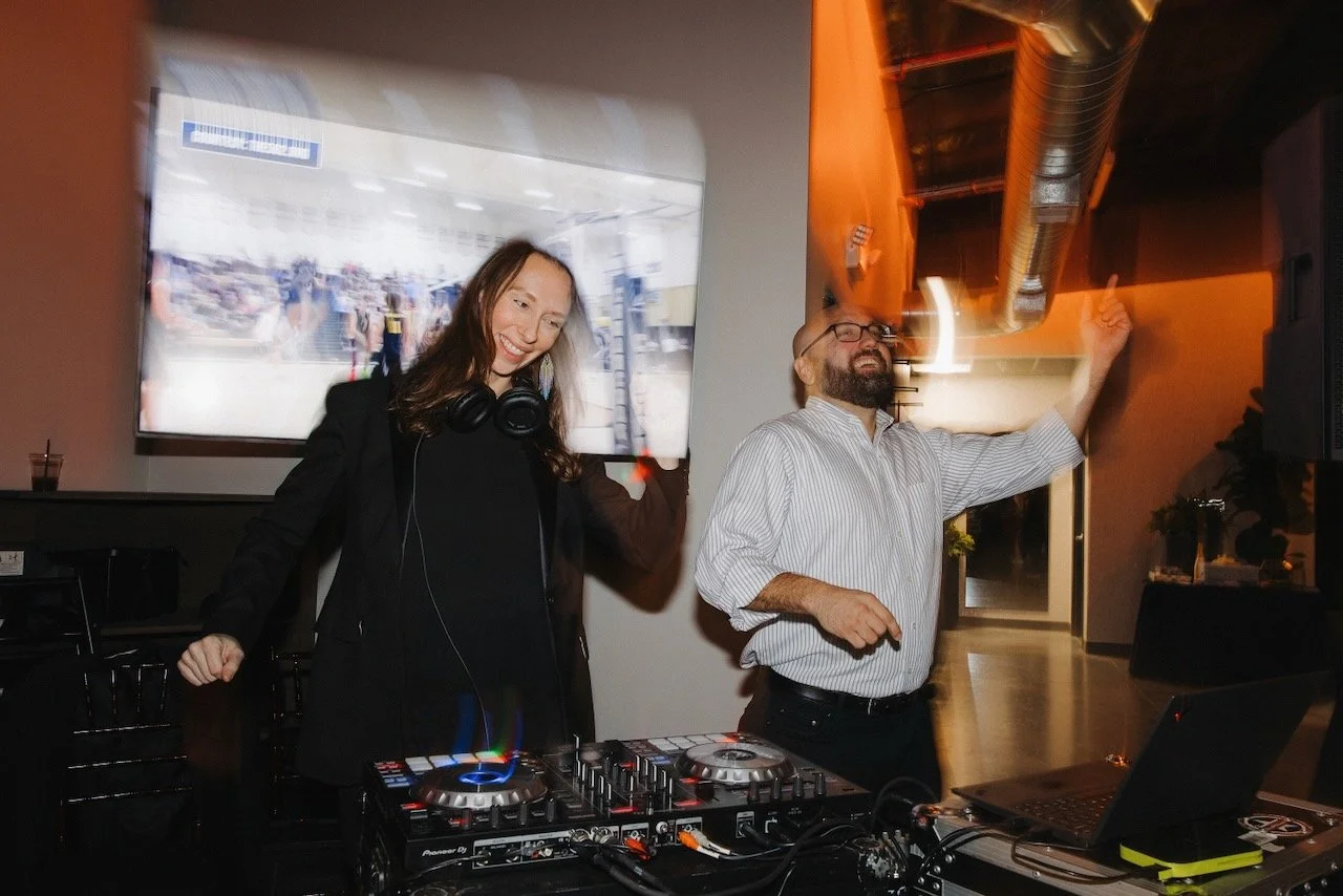 Two DJs standing behind DJ booth at a Bosana Events wedding