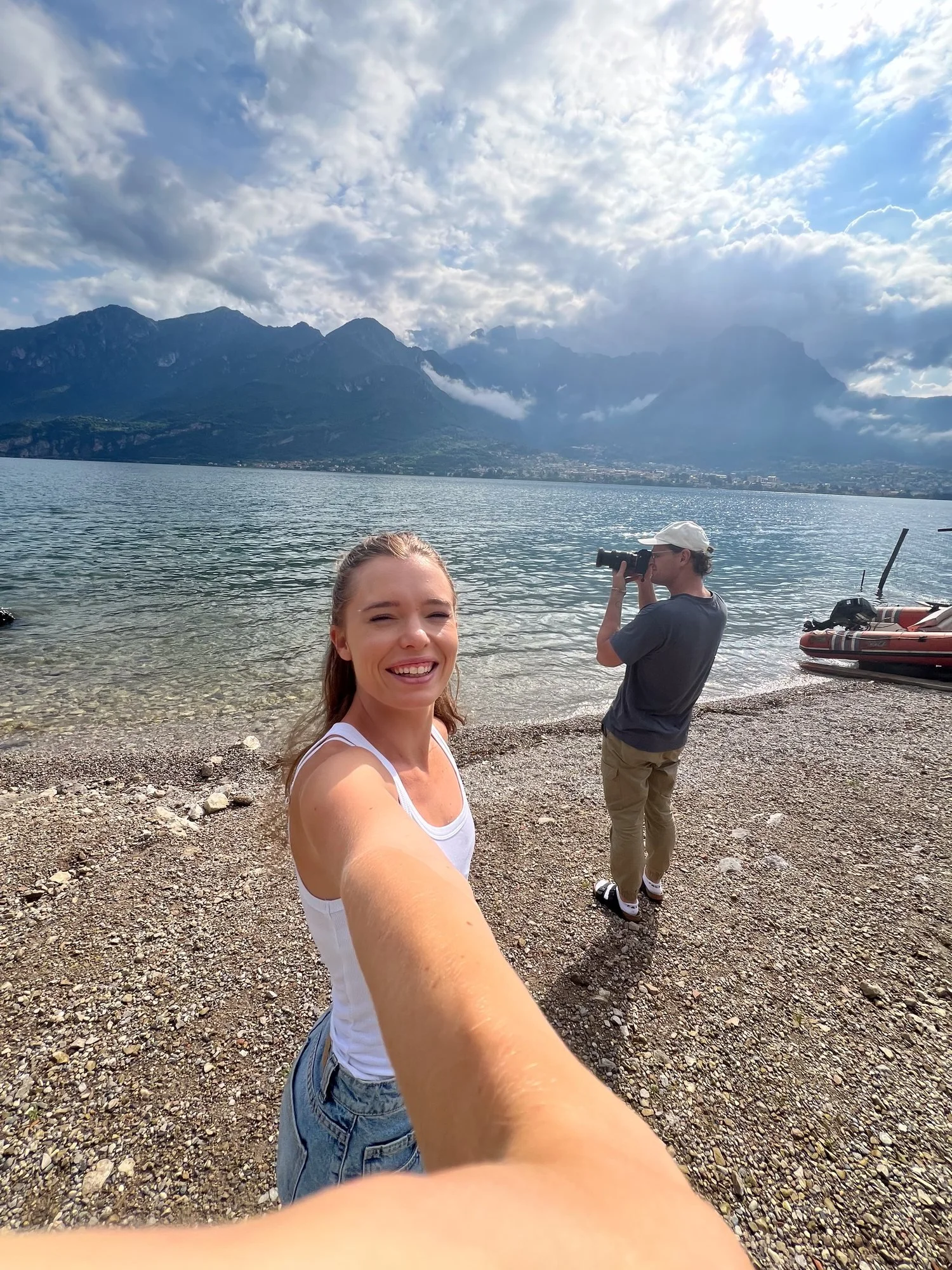 Claire on the shore of Lake Como with the mountains behind