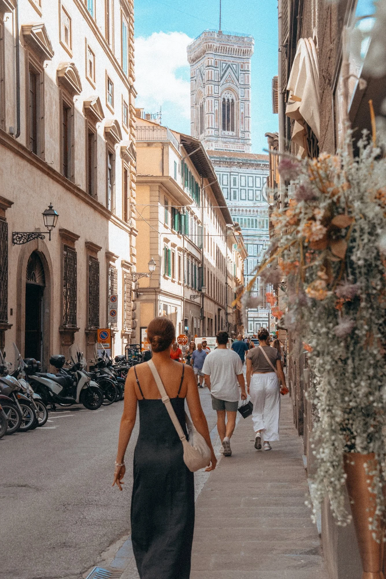 Claire walking down a Florence street towards Giotto's Bell Tower