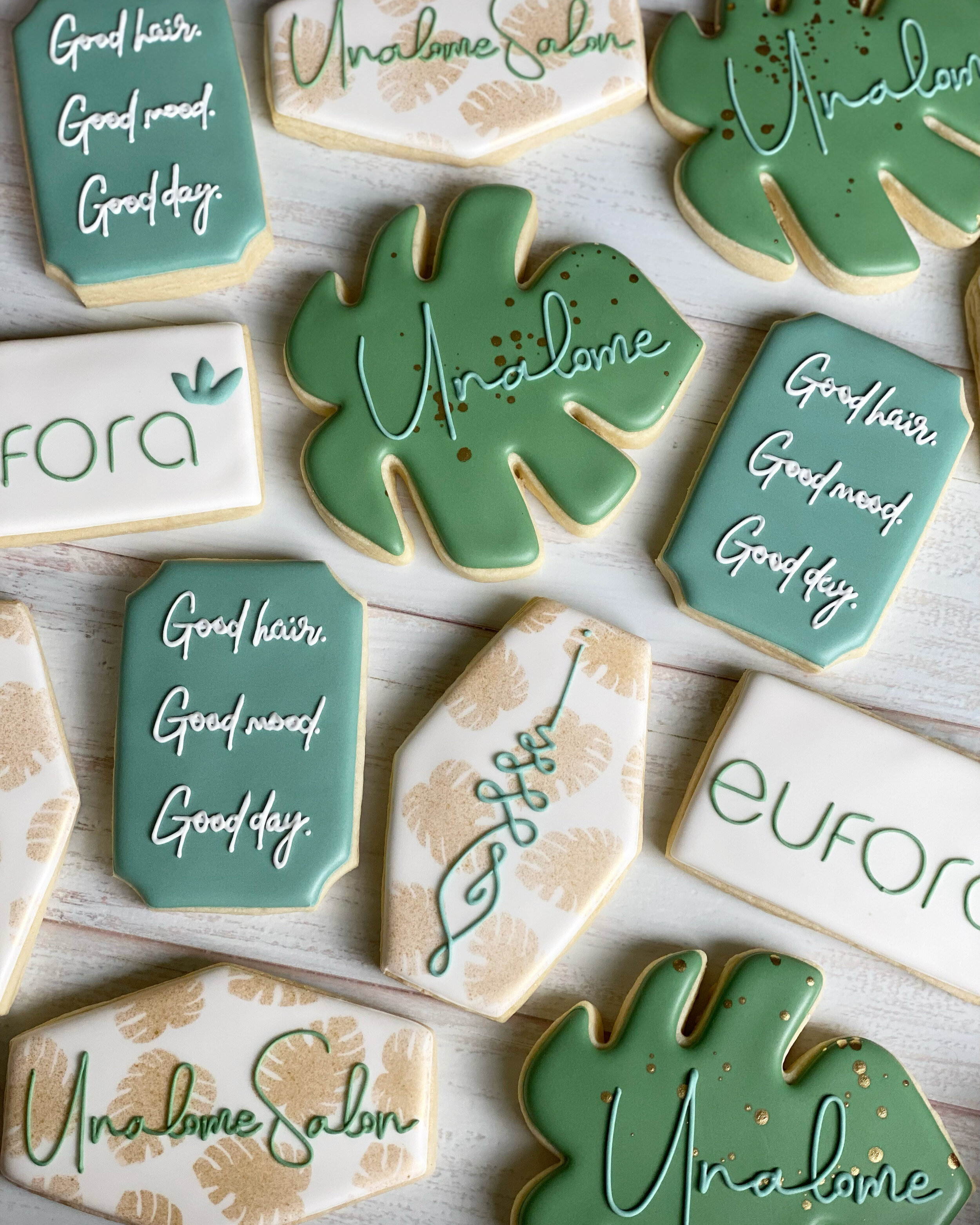Decorative cookies with messages such as 'Good hair', 'Good mood', and 'Welcome home' written in icing.