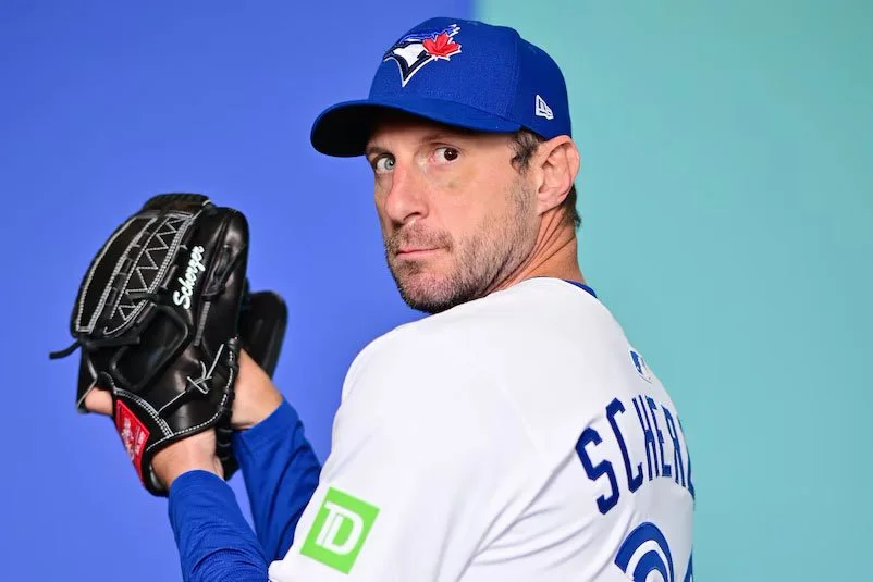 Toronto Blue Jays starting pitcher Max Scherzer looking at camera with a blue background